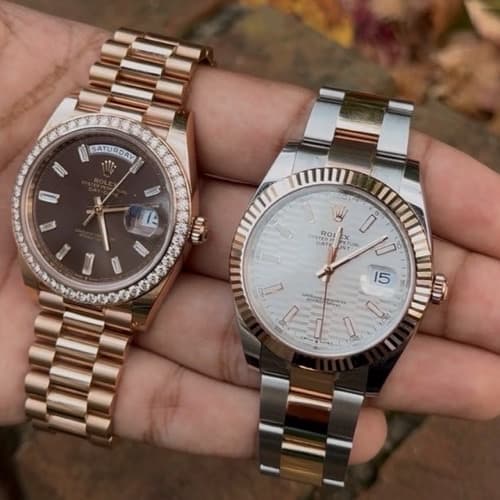 Editorial close-up of a luxury chronograph watch on smooth river stones