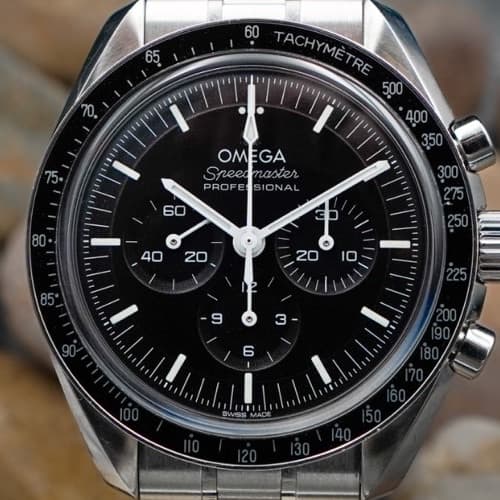 Classic chronograph with black dial and tachymeter bezel on stone